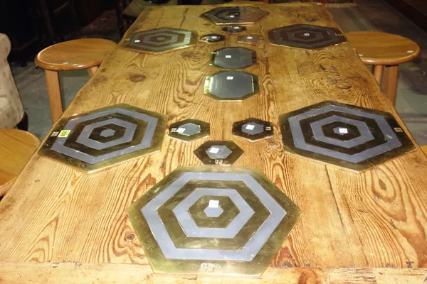 A set of David Marshall bronze and polished white metal hexagonal place mats and associated stands, (14).   C5