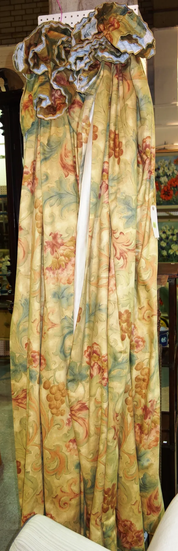 Curtains; two pairs of lined pale yellow ground and floral patterned curtains, the fall 219cm x 104cm wide. D6