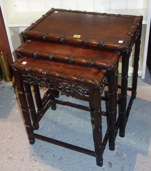 A nest of three 20th century Chinese tables, with carved decoration, (3).  G4