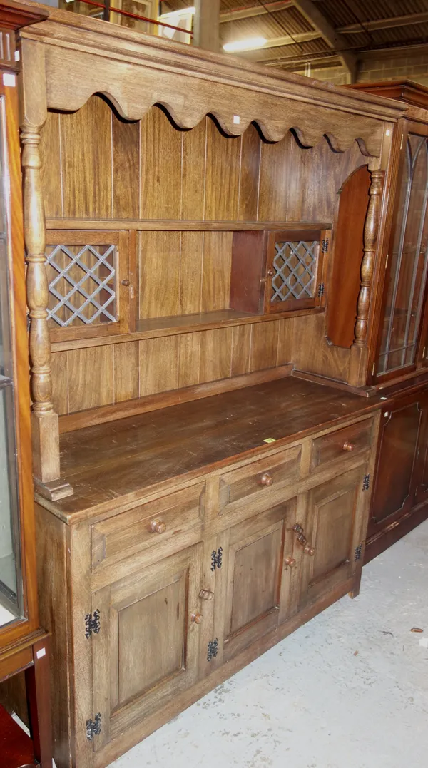 A 20th century walnut dresser, with two tier pate rack and a pair of cupboards, over three drawers and three cupboard base, 137cm wide x 185cm high.