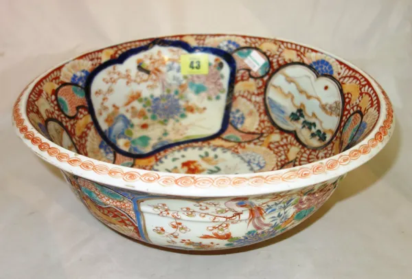 A Japanese Imari bowl, Meiji period, painted with panels of birds in flowering branches and views of Mount Fuji, the interior painted with a central p