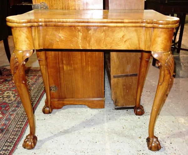 A 19th century walnut foldover card table, on shell carved cabriole supports, 81cm wide.  I5