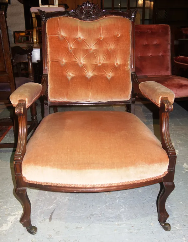 An Edwardian walnut framed open armchair, with pink button upholstery.  I9