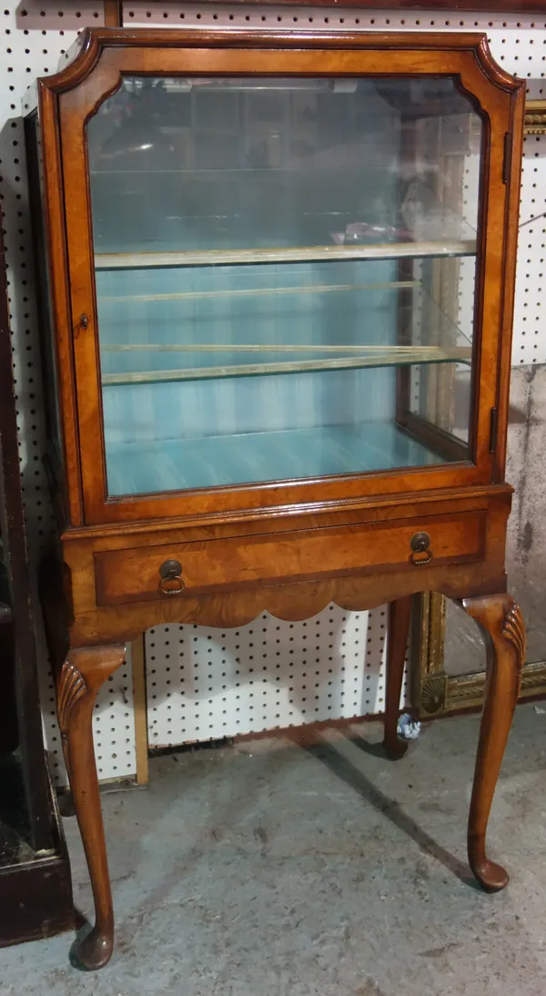 An Edwardian walnut glazed display cabinet, with single drawer and shell carved cabriole supports, 63cm wide.  M4