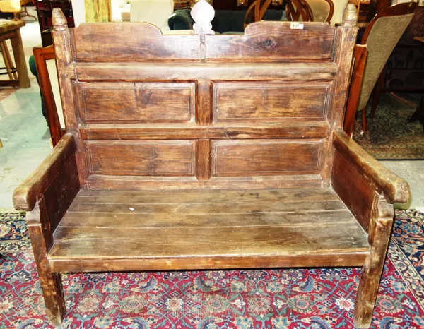 A 19th century softwood panel back bench, on block supports, 125cm wide.   E4