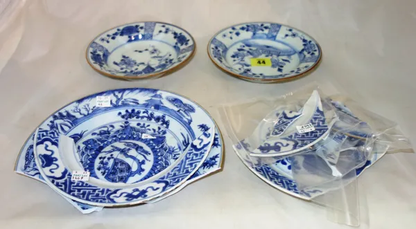 A pair of small Chinese blue and white plates, 18th century, each painted in the centre with a bird perched on a branch in a fenced garden beneath a p
