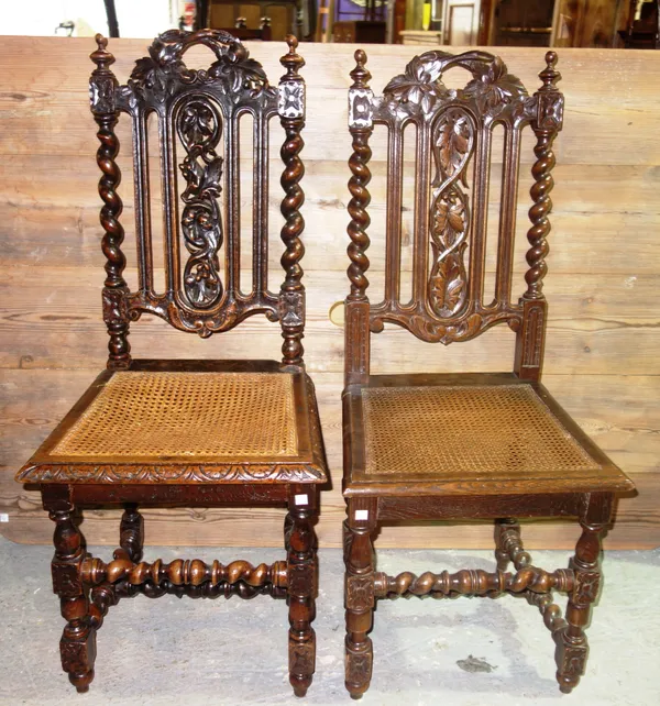A set of four Victorian carved oak dining chairs with barley twist supports and a similar set of three, (7).  F7