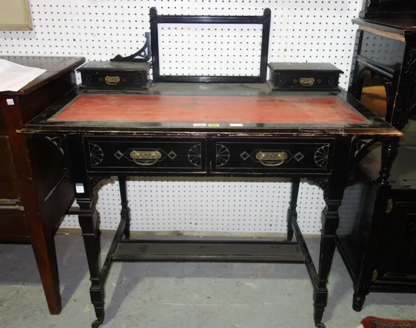 A 19th century Aesthetic movement ebonised writing table, with red leather top and turned supports, 106cm wide. J11