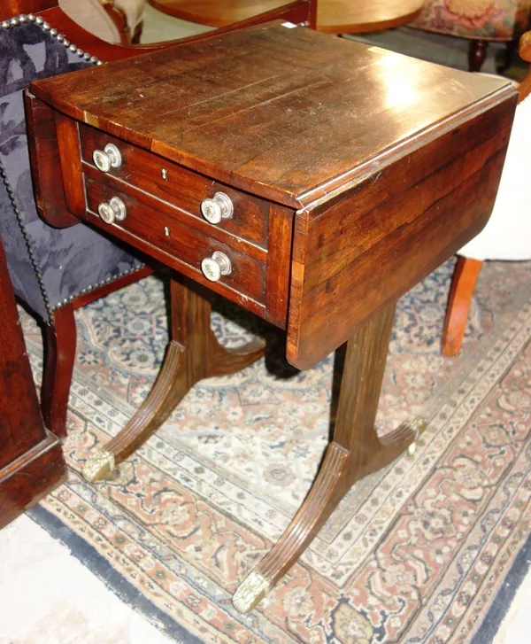 An early 19th century rosewood twin drop-leaf table, on dual end supports, 42cm wide x 70cm high.   G6