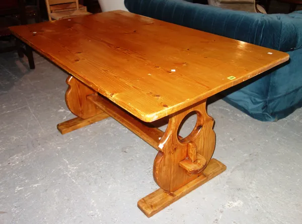 A 20th century pine kitchen dining table united by a stretcher, 143cm long x 75cm high.  E6
