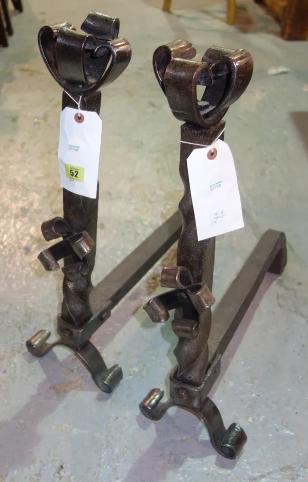 A pair of modern steel andirons, each with scroll finial over a barleytwist stem and two shaped feet, each 61cm high (2).   S3B
