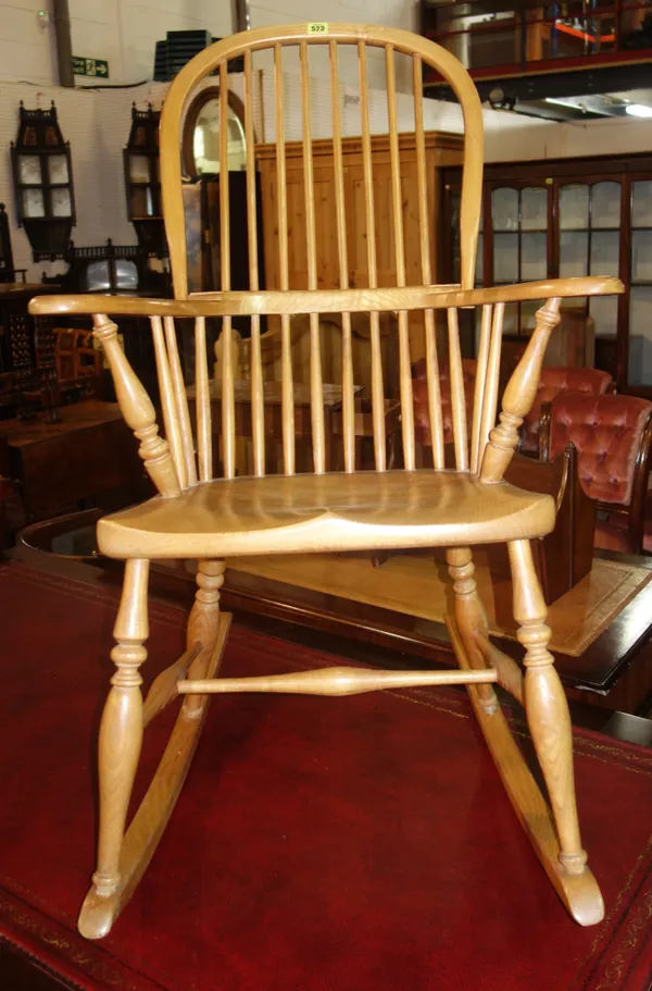 A 20th century elm seated bow back rocking chair.    K8