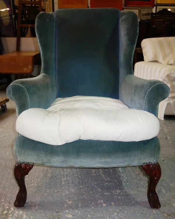 A 19th century mahogany framed wingback armchair, on hairy claw feet.  B7