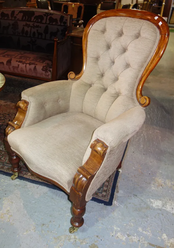 A Victorian mahogany framed button upholstered armchair.  F4