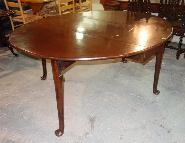 A George III mahogany drop leaf dining table, on turned legs, with pad feet, 143cm wide x 71cm high.   G7
