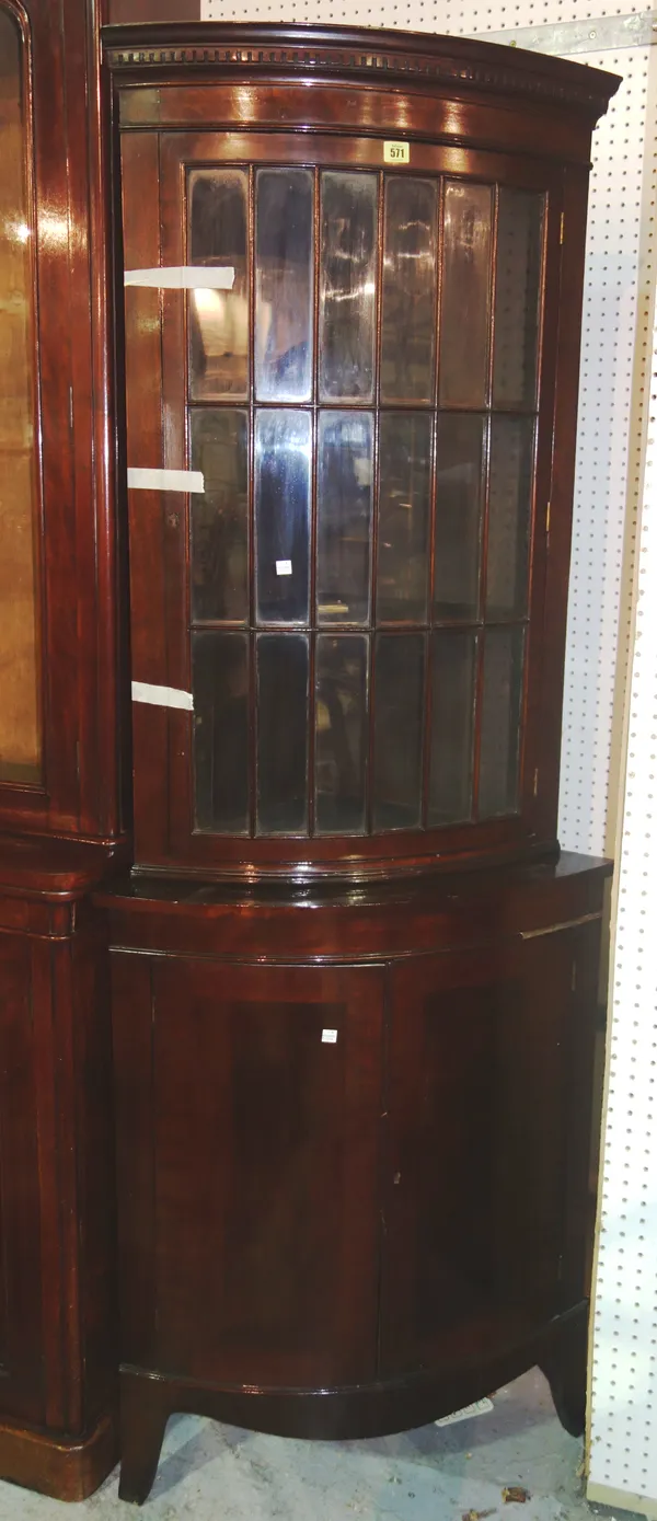 An Edwardian mahogany bowfront corner display cabinet, on splay bracket feet, 194cm high.   M6