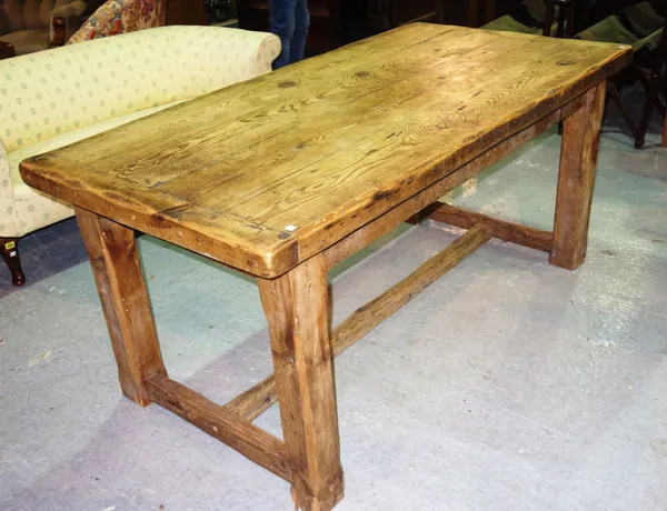 A 19th century pine dining table, on square block supports, united by stretcher, 169cm wide x 78cm high.  C4
