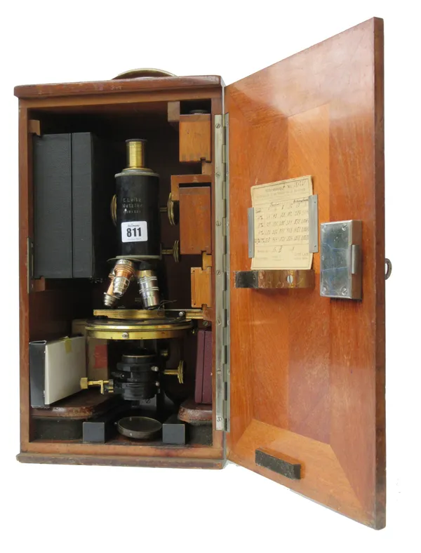 E. Leitz Wetzlar; an ebonised and gilt brass microscope, late 19th century, with rack and pinion focusing and fine adjustment, over a circular adjusta