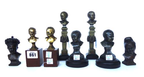 A pair of ormolu busts of young children, 19th century, one modelled crying and the other smiling, each on a chamfered column and black marble plinth,