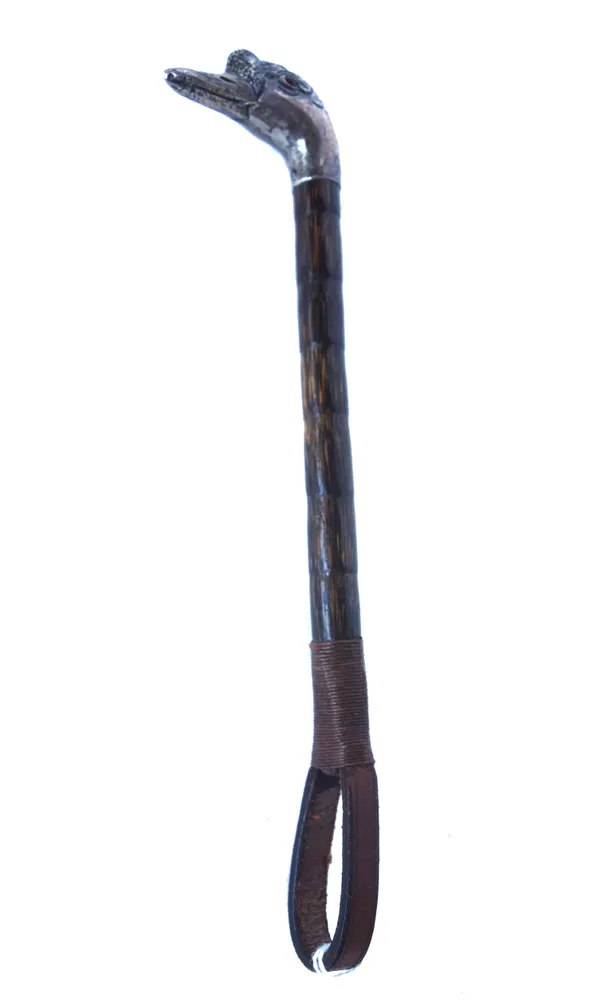 A silver and bamboo child's riding crop (formerly a parasol handle), the silver pommel cast as a duck's head, hallmarked London 1906, with inset red g