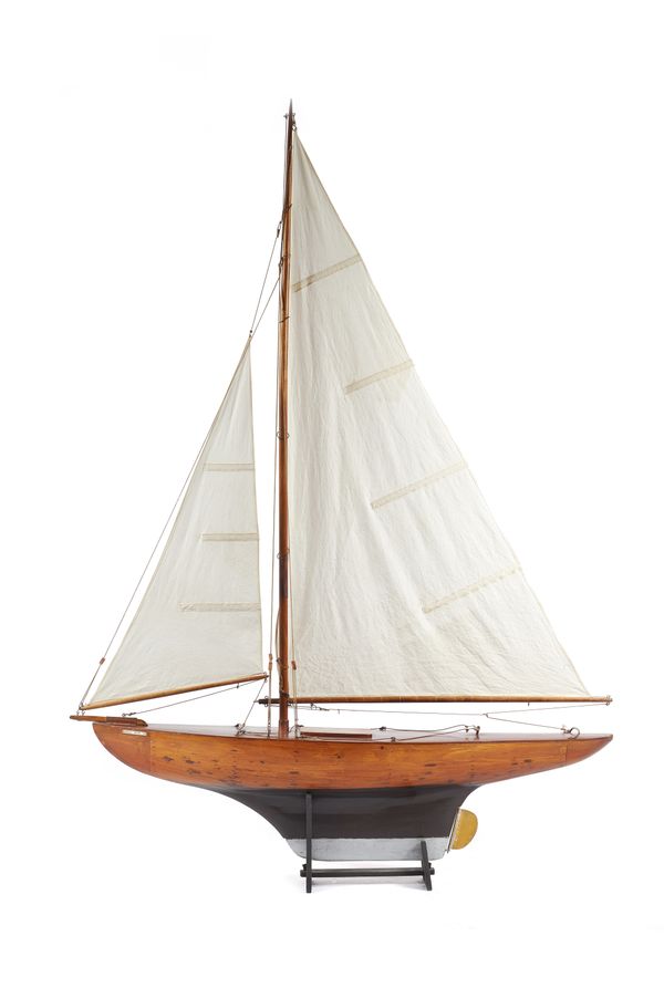 A wooden scale model yacht, 'English Rose 36', circa 1954, fully rigged and with a black and silver painted wooden hull, 98cm x 130cm.  Illustrated