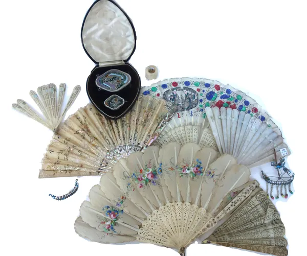 A Cantonese mother-of-pearl fan, late 19th century, engraved all over with Oriental scenes, 18cm long, a Chinese painted feather and carved bone fan,