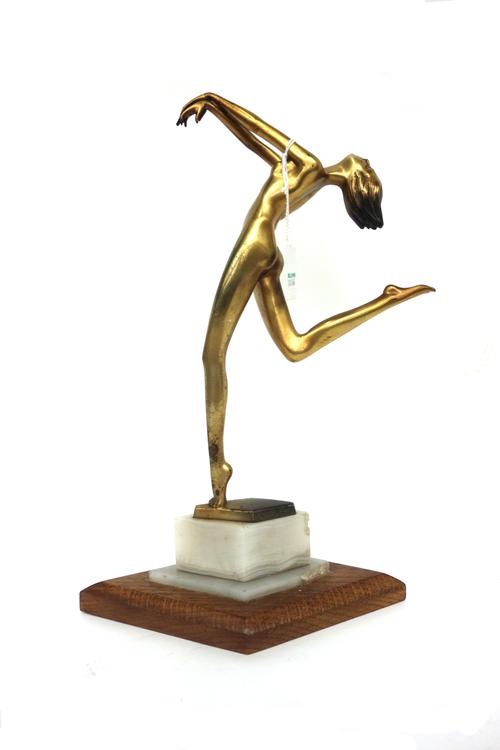 An Austrian Art Deco gilt bronze figure of a female nude, circa 1925, signed 'ADOLPH', raised on a rhomboid shaped hardstone and oak base, 32.5cm high