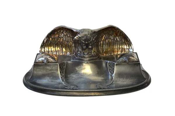 A W.M.F silvered metal 'Eagle' inkwell and pen tray, circa 1910, the inkwells with hinged covers, impressed marks to rear, 35cm wide.  Illustrated