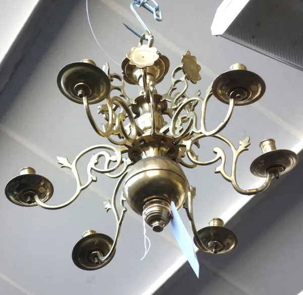 A Dutch brass six branch chandelier, 17th century, the bulbous stem issuing six scroll branches, interspersed with two smaller tiers of swan and folia