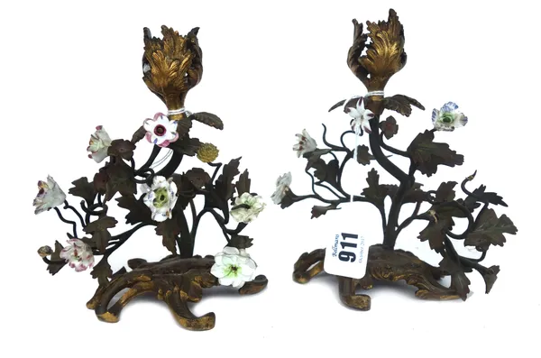 A pair of French ormolu tole and porcelain mounted candlesticks, late 19th century, each on a Rococo style scroll base (a.f), 16cm high, (2).