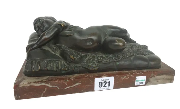A French patinated bronze figure of a recumbent infant, late 19th century, unsigned, on a rouge marble plinth, 25.5cm wide, and a brass novelty 'horse