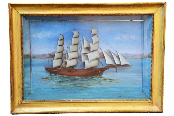 A polychrome painted carved wooden diorama, depicting a fully rigged sailing ship at sea, indistinctly signed and dated 1900, framed and glazed, 83cm