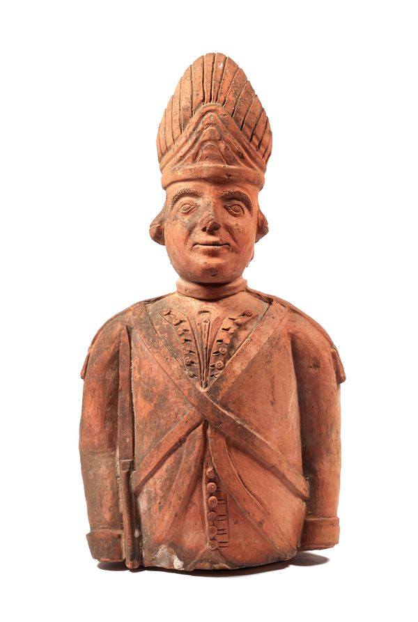 A large terracotta bust, early 20th century, depicting a Continental soldier, possibly a tobacco advertising figure. (a.f), 103cm high.  Illustrated