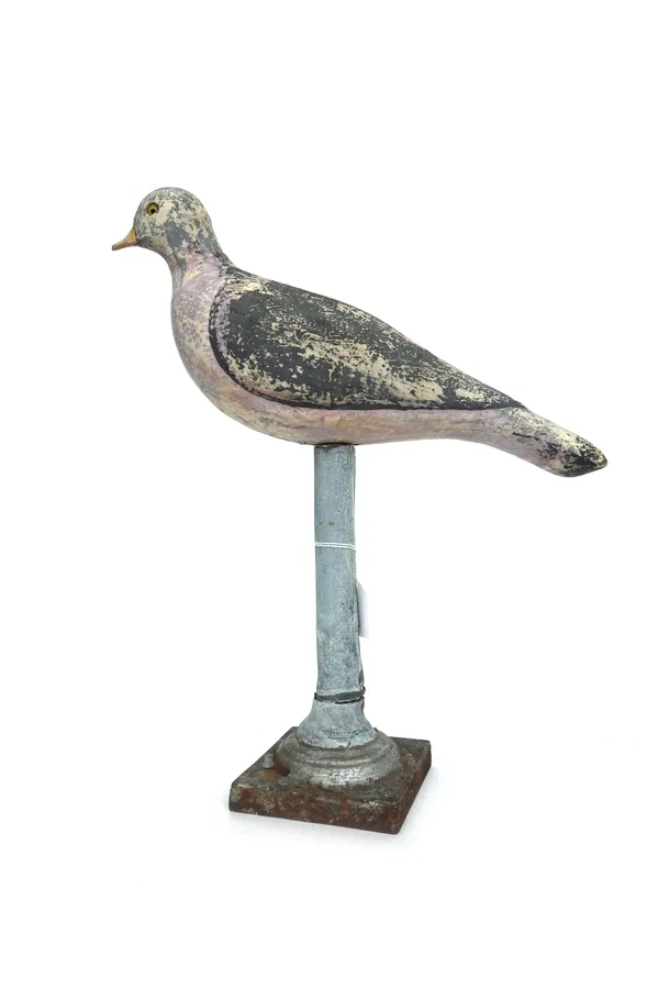 A polychrome painted wooden pigeon on a metal bound wooden stand, 37.5cm high, a carved wooden hand, a wooden wool-winding machine, and a polychrome p
