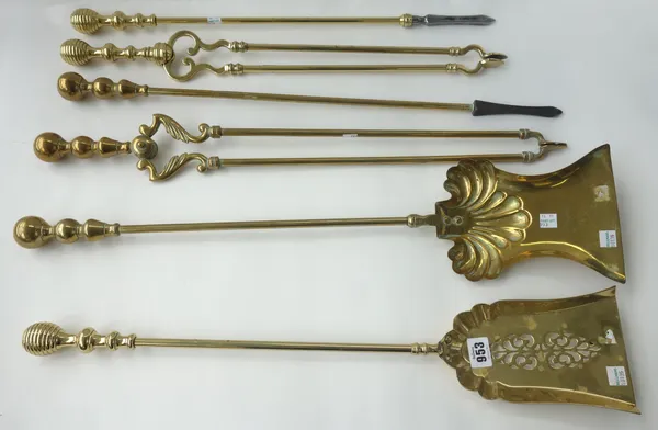 A set of three Victorian brass fire irons with ribbed spherical handles, plain shafts and a pierced shovel (62.5cm), and one further set with triple k