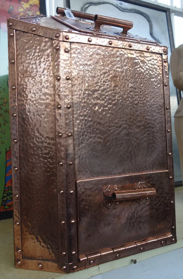 An unusual copper Arts and Crafts style grain/coffee bin, of angular form, with two hinged flaps and a carry handle and all over beaten finish, 54.5cm