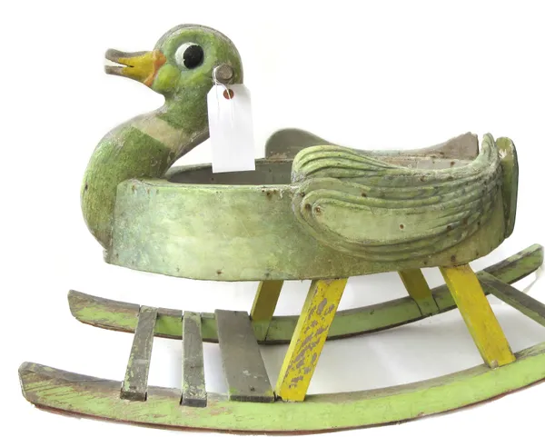 A child's polychrome painted wooden rocking duck on slatted bow rockers, 90cm long, and a black painted tin weather vane, modelled as a knight's helme