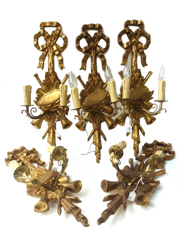 A set of six Louis XVI style giltwood two branch wall appliques, modern, each with ribbon tied surmount over a foliate backplate adorned with musical