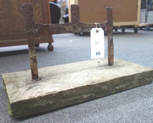 A Victorian wrought iron boot scraper, of plain divisional form, in a stone rectangular base, 53cm wide.