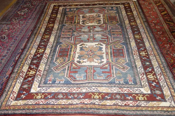 A Chachan rug, Afghan, the indigo field with two bold medallions, with birds, figures and animals, a burgundy crab medallion border, 242cm x 180cm.