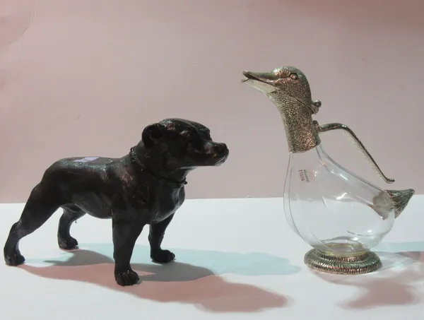 A composite bronze model of a Staffordshire Bull Terrier, 20cm high and a novelty white metal mounted glass claret jug modelled as a duck, 26cm high,