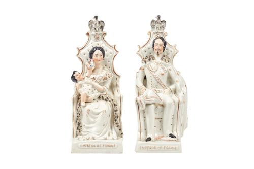 A pair of Staffordshire portrait figures, Emperor and Empress of France, 19th century, gilt over white, each modelled seated in a throne, with a gilt