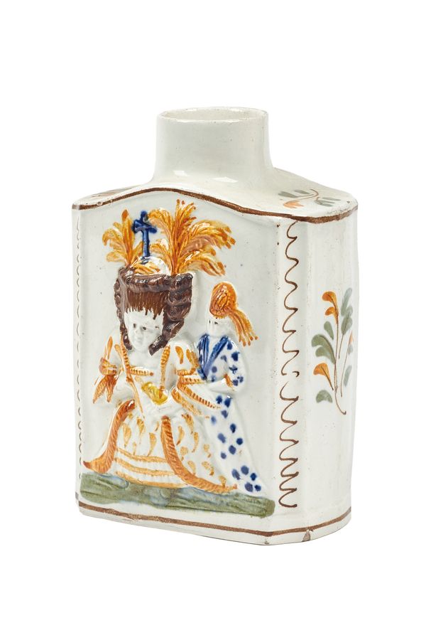 A Pratt ware 'Macaroni' tea caddy, late 18th/early 19th century, relief moulded with figures and polychrome decorated against a canted rectangular gro