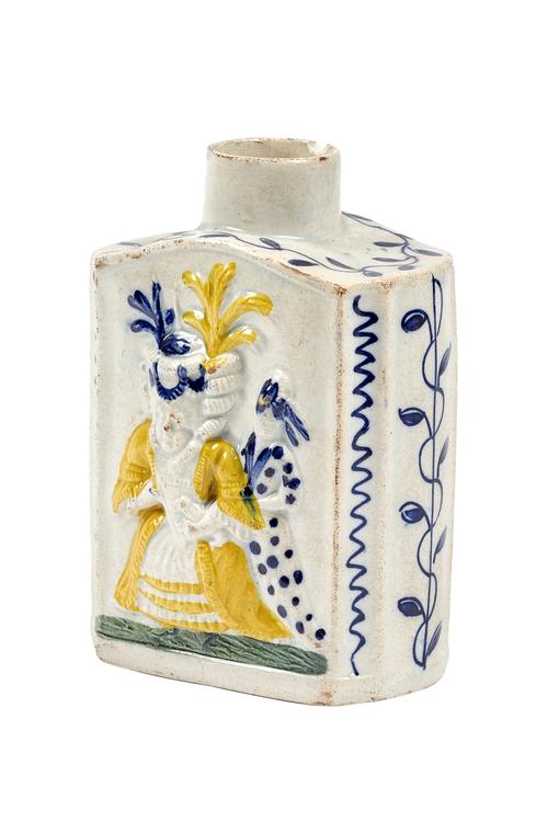 A Pratt ware 'Macaroni' tea caddy, late 18th/early 19th century, relief moulded with figures and polychrome decorated against a canted rectangular gro