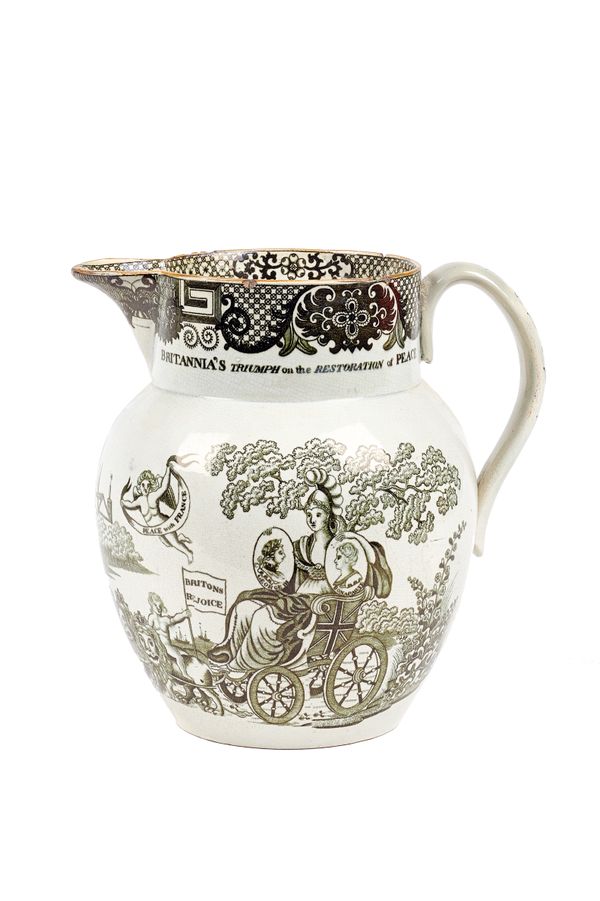 An English pearlware jug, early 19th century, depicting a bat printed allegorical scene of the restoration of peace to Amiens, with a wide foliate bor