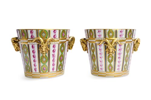 A pair of Dresden porcelain jardinieres, 20th century, each with three applied gilt rams head handles against a gilt foliated decorated ground, blue p