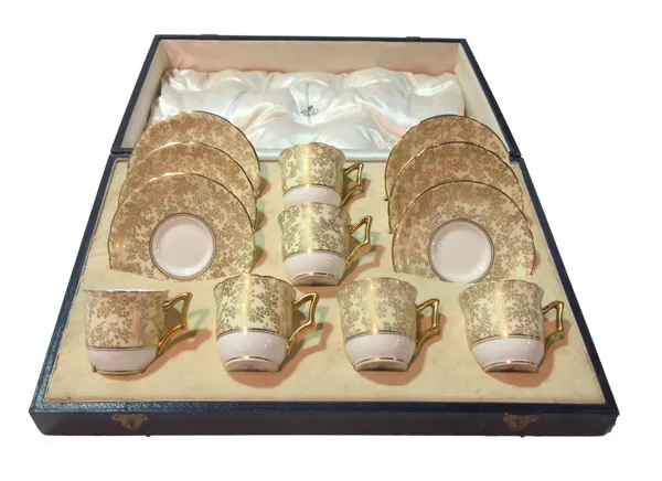 A Royal Worcester gilt decorated six cup and saucer set for Asprey, cased.  TALLCAB