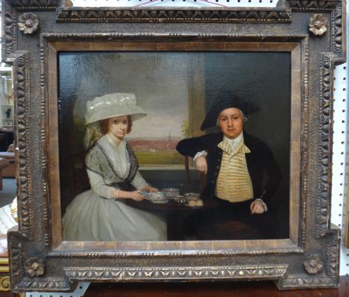 Circle of John Thomas Seton, portrait of a lady and gentleman, seated by a window with a landscape beyond, oil on canvas, 43cm x 52cm.