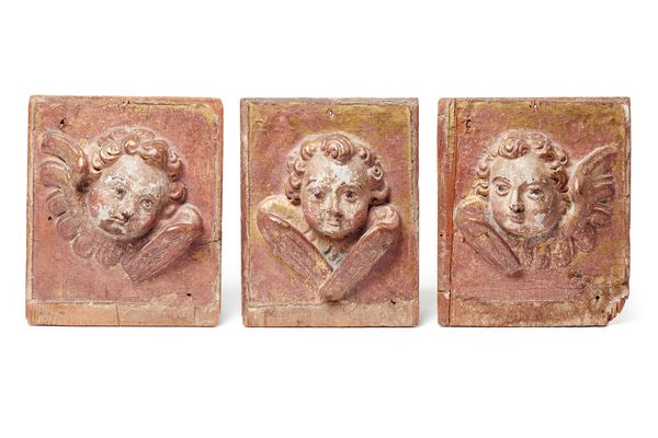 A set of three 18th/19th century carved pine and gesso plaques of winged cherubs, each 15cm wide x 18cm high.  Illustrated
