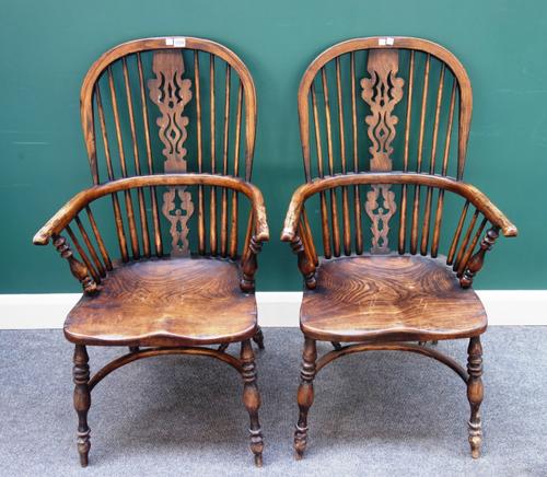 A pair of George III style elm and ash Windsor chairs, each with pierced splat and solid seat, on turned supports united by crinoline stretcher, 50cm
